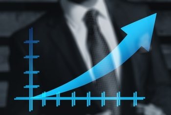 Man in suit with graph showing increasing stats