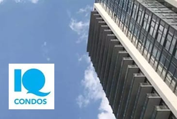 Exterior view of IQ Condos with logo overlay.