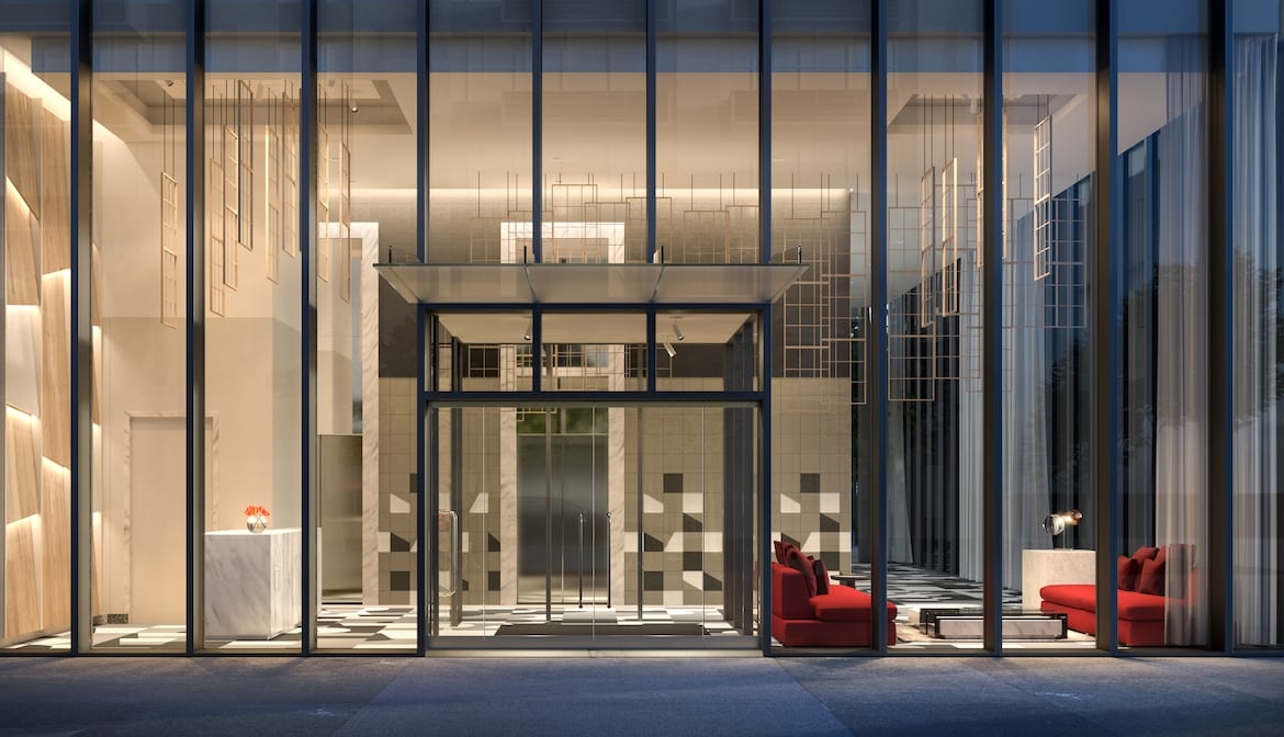 Rendering of Television City Condos exterior of lobby looking through windows at night