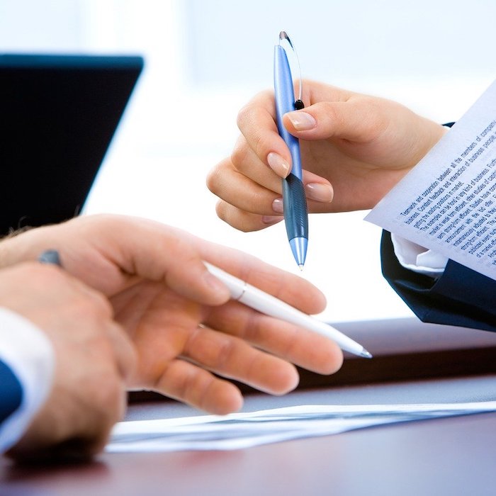 Woman and man going through legal real estate documents together.