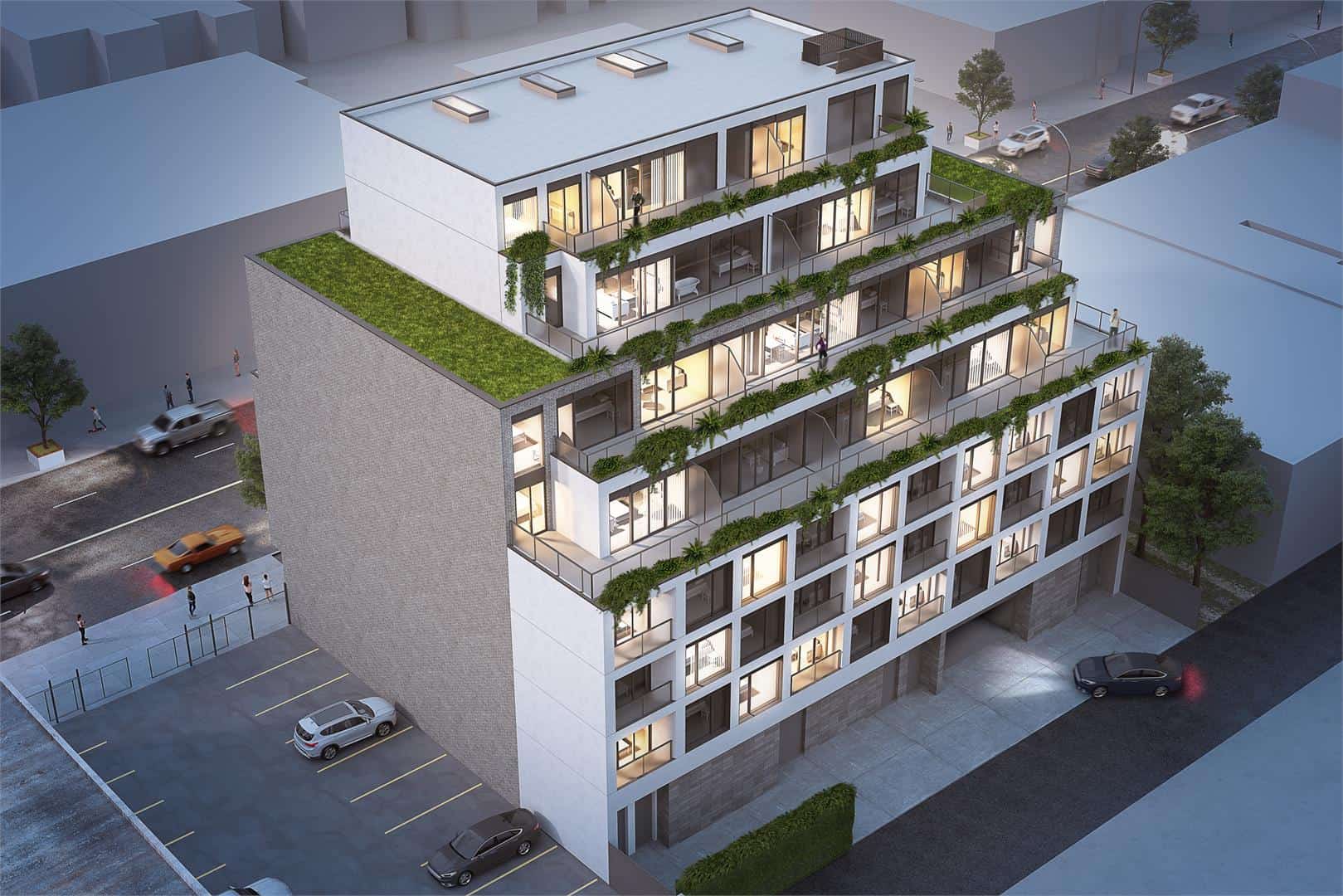 Rendering of THEO Condos Danforth Toronto exterior from birds-eye-view at night.