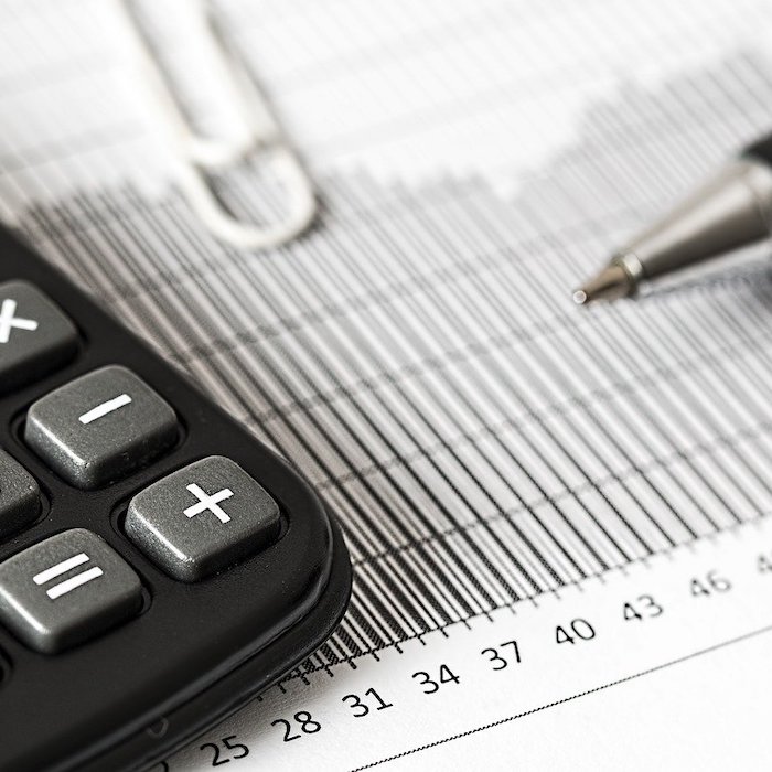 Calculator and pen on a paper.