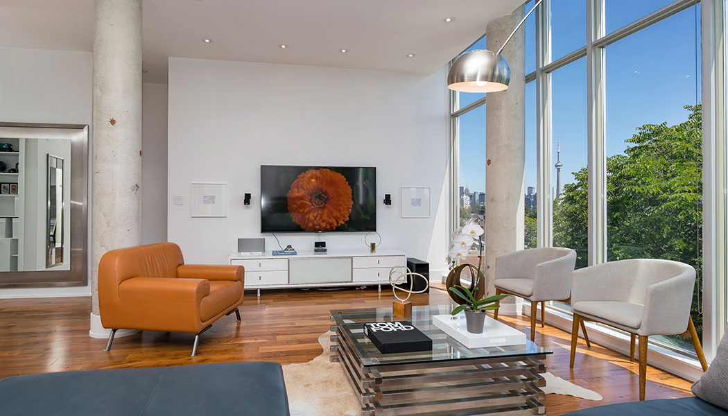 modern living room with big windows and seating.