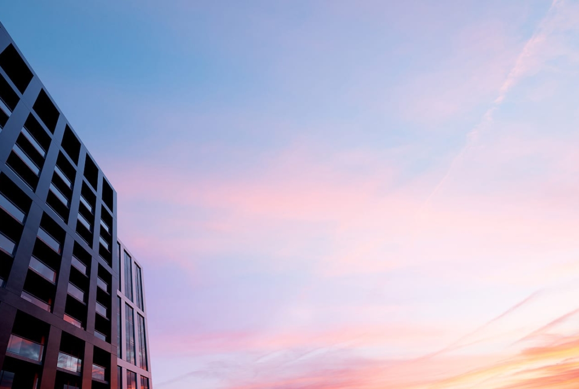 Exterior rendering of M5 Condos and a pastel sunset